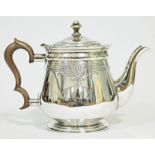 A silver teapot with dentilated rim, bright cut engraved decoration to body, horn finial and