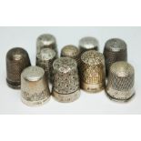 A group of nine silver thimbles and another, various marks.