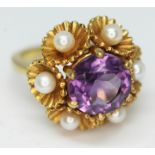 A 9ct gold ring set with an amethyst coloured stone and pearls, marked '9', gross wt. 7.9g, size N/