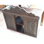 A carved oak table cabinet, length 87cm.