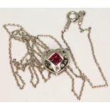 A 14ct white gold diamond and ruby heart shaped pendant on 14ct white gold chain, both marked '14K',