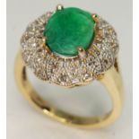 An emerald and diamond ring, the central oval cut emerald approx. 2.14ct, band marked '14K', gross