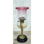 A Victorian brass column oil lamp with cut glass reservoir, pot base and etched glass shade,