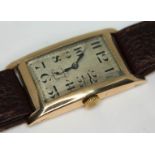 An Art Deco 9ct gold wristwatch, case length 41mm, later leather strap.