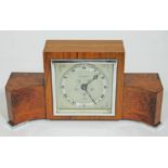 An Art Deco chrome mounted walnut mantle clock by Elliott, length 26cm.