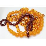 Three sets of amber coloured beads.