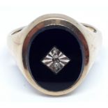 A hallmarked 9ct gold black onyx and diamond signet ring, gross wt. 6.2g, size Q/R.