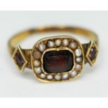 A 19th century gold ring set with half cut pearls, purple and red stones, band unmarked, gross wt.