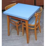 A 1950s blue formica drawer leaf kitchen table and two chairs.