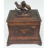 A Black Forest carved wooden decanter box, height 47cm.