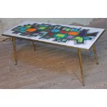 A retro abstract tile top coffee table with spindle legs, length 103.5cm.