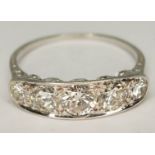 An Art Deco style five stone diamond ring, total approx. diamond wt. 1.46 carats, white metal band