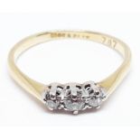 An 18ct gold three stone diamond ring, marked '18ct PT', gross wt. 2.3g, size P.