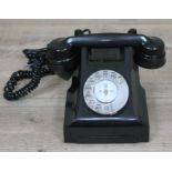 A black bakelite telephone.