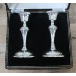 A pair of military hallmarked silver candlesticks in presentation case.