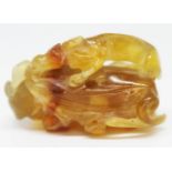 A Chinese agate carving formed as a dragon breathing fire, length 42mm.