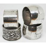 A group of four hallmarked silver serviette rings.