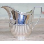 An Edwardian half fluted silver cream jug with gilt interior, William Hutton & Sons, London 1907,