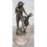 A cast metal figure depicting a shepherd boy wearing a hat and holding a stick with ram on onyx