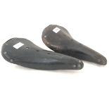 Two vintage bicycle saddles comprising a Brooks Champion Standard B.17 together with a Brooks