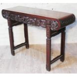 A Chinese altar table, late 19th century, carved frieze with scroll ends and carved square legs,