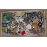 A tray of bric a brac including two ACME whistles, military cap badges, mother of pearl, bone, etc.