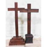 Two wooden crucifixes, one on burr wood three step base, the other with Gothic carved base, height