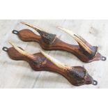 A pair of taxidermy antler coat hooks.