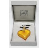 A Lalique amber glass heart shaped pendant with yellow metal loop and black cord