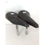 Two vintage leather bicycle saddles comprising a Wrights and Lycett