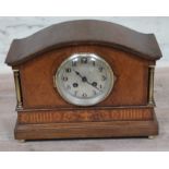 An Edwardian oak mantle with domed top, steel dial with gothic numerals, brass pillars and classical