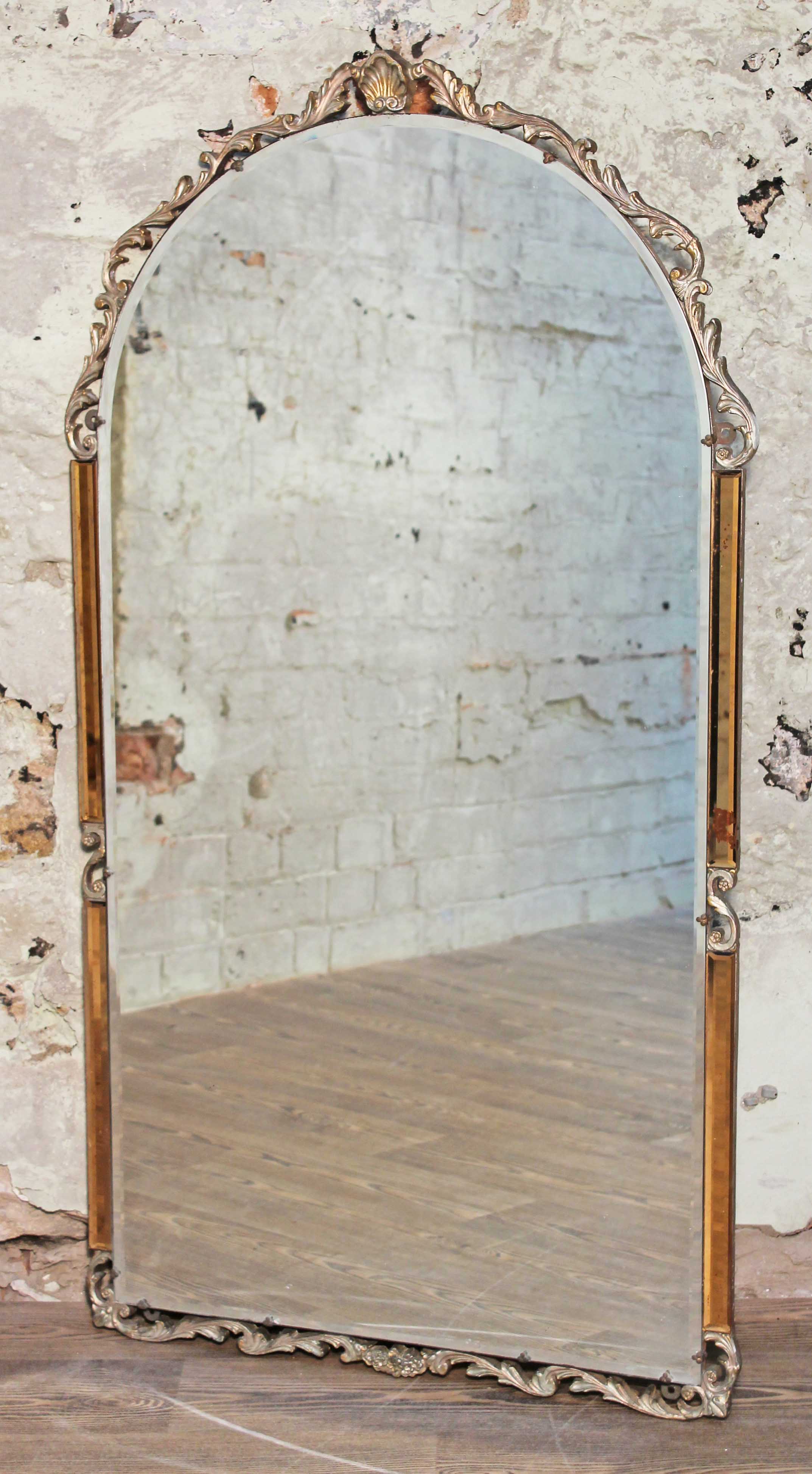 An Art Deco mirror with moulded mounts and amber glass sides, width 69cm & height 125cm. Condition -