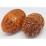 Two carved and pierced coquilla nuts.