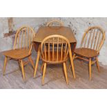 An Ercol Blonde elm and beech drop leaf table and four chairs. Condition - general wear throughout