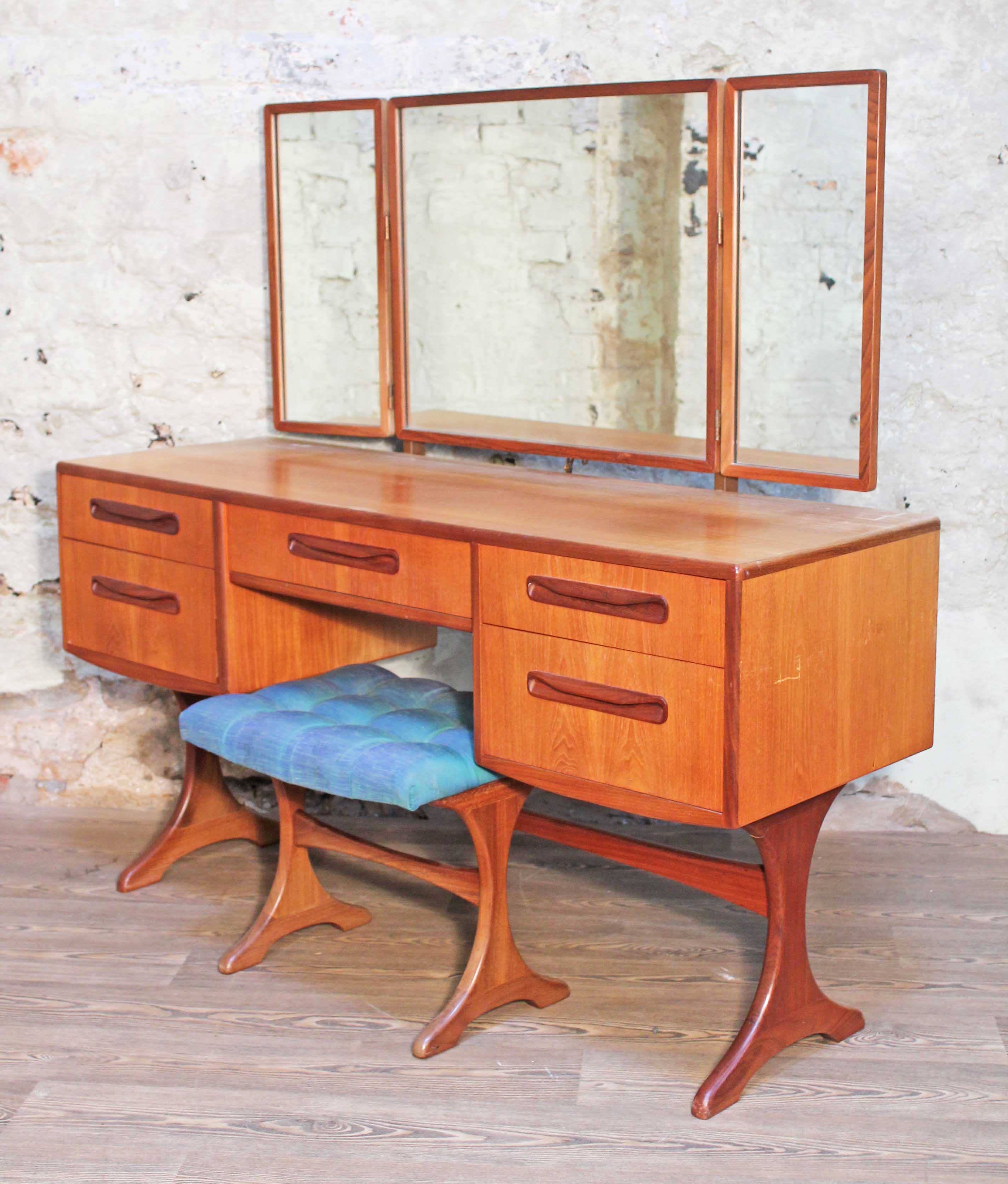 A G-Plan teak dressing table with triple mirror and stool, length 137cm, depth 50cm & height