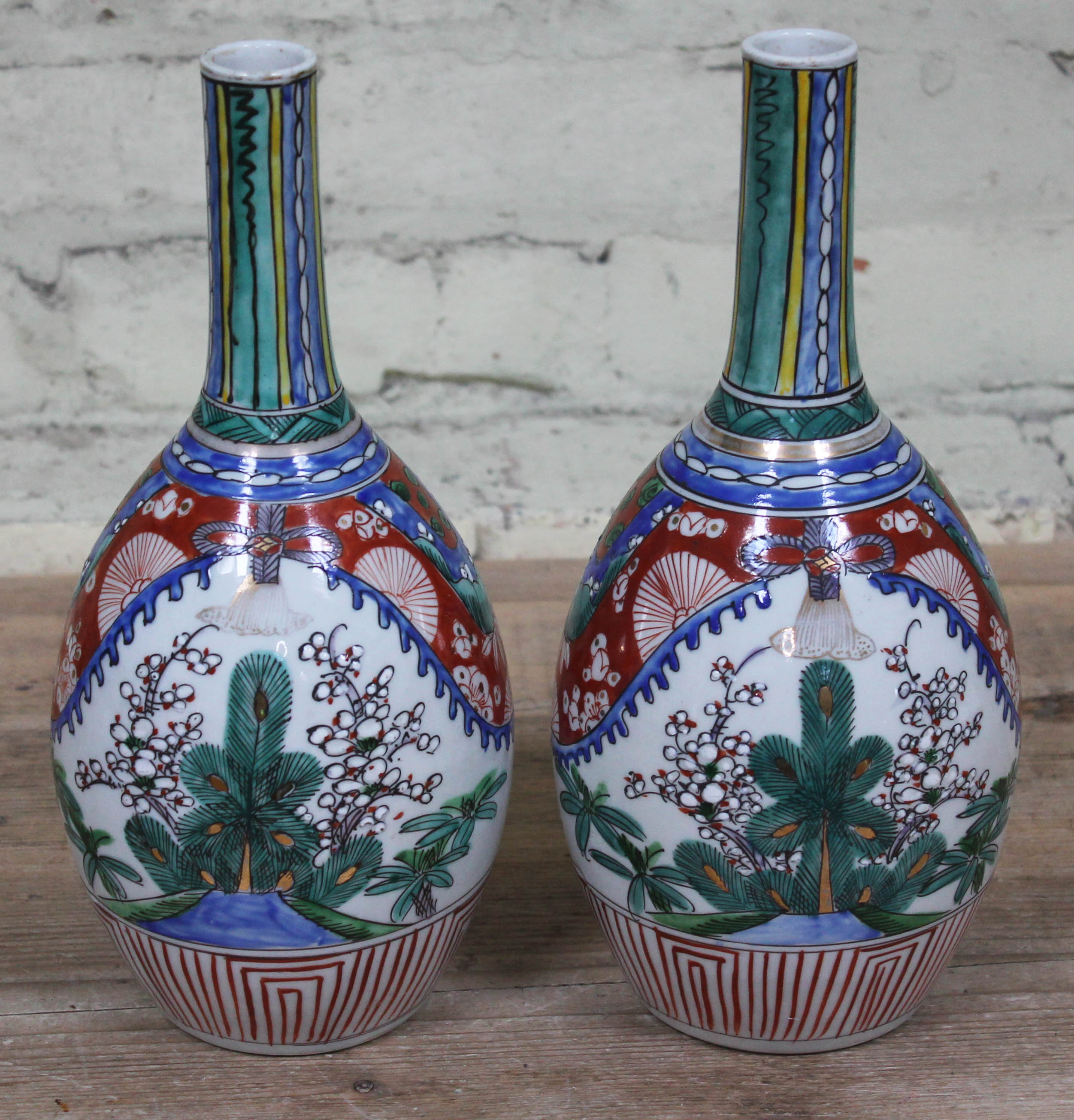 A pair of Japanese Arita porcelain bottle vases, height 30.5cm. Condition - one having crazed line