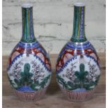 A pair of Japanese Arita porcelain bottle vases, height 30.5cm. Condition - one having crazed line