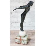 An Austrian Art Deco style bronzed spelter figure depicting a female diver on spherical and