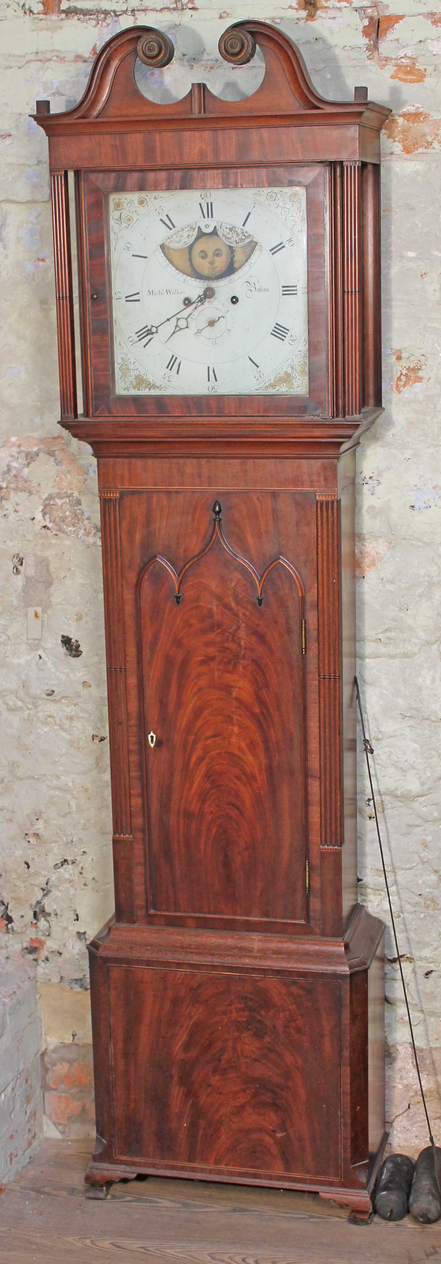 A 19th century eight day long case clock, the hood with swan neck pediment and fluted columns,