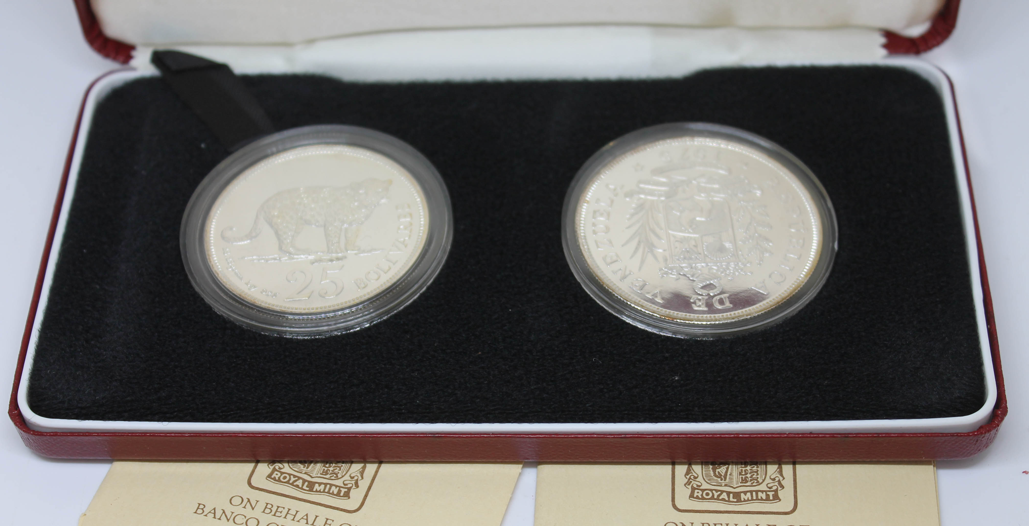 A cased set of two Venezuela silver proof coins, 25 & 50 bolivares, Royal Mint, boxed with