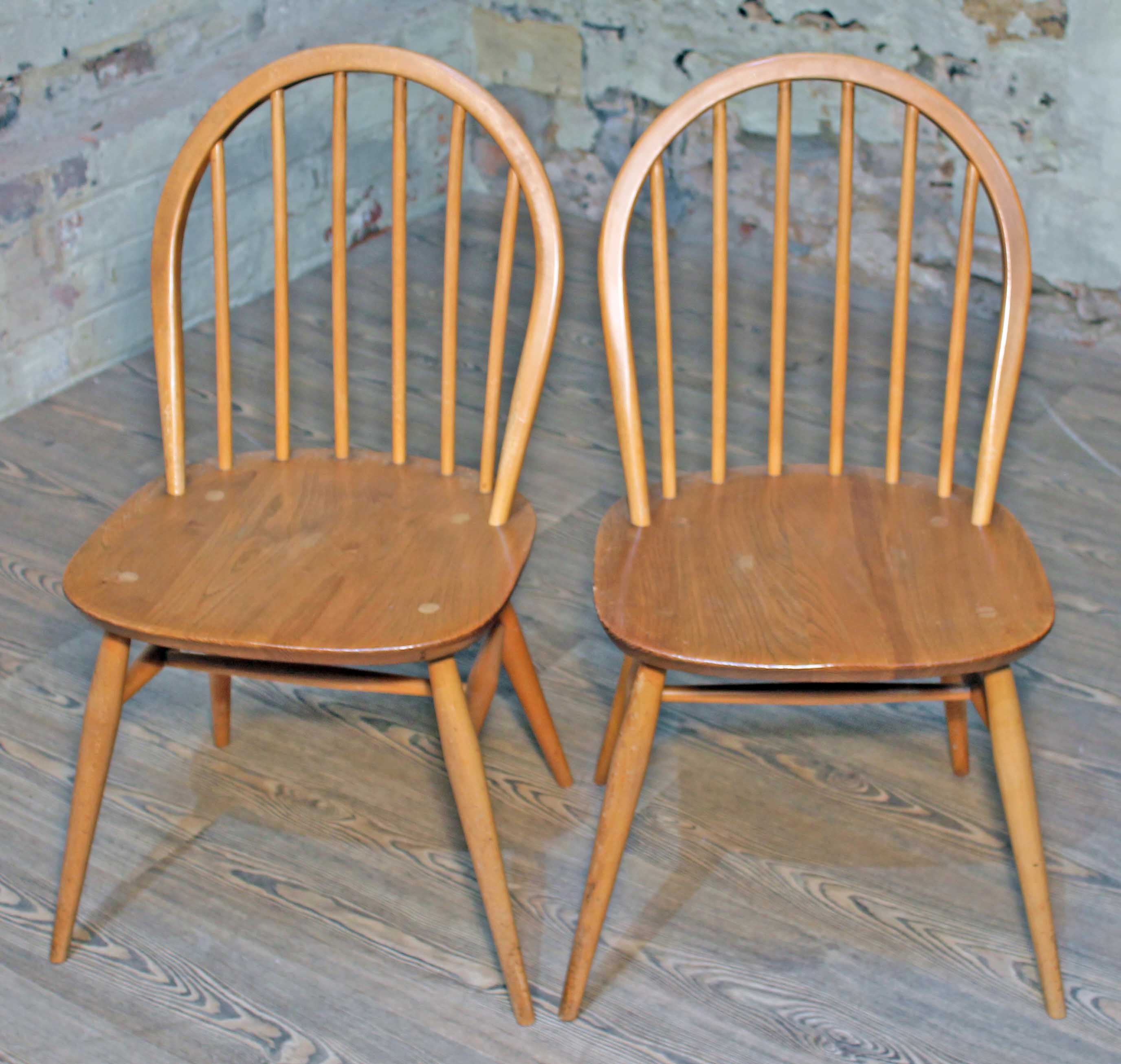 A pair of Ercol Blonde elm and beech spindle back chairs. Condition - good, minor wear.
