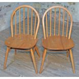A pair of Ercol Blonde elm and beech spindle back chairs. Condition - good, minor wear.