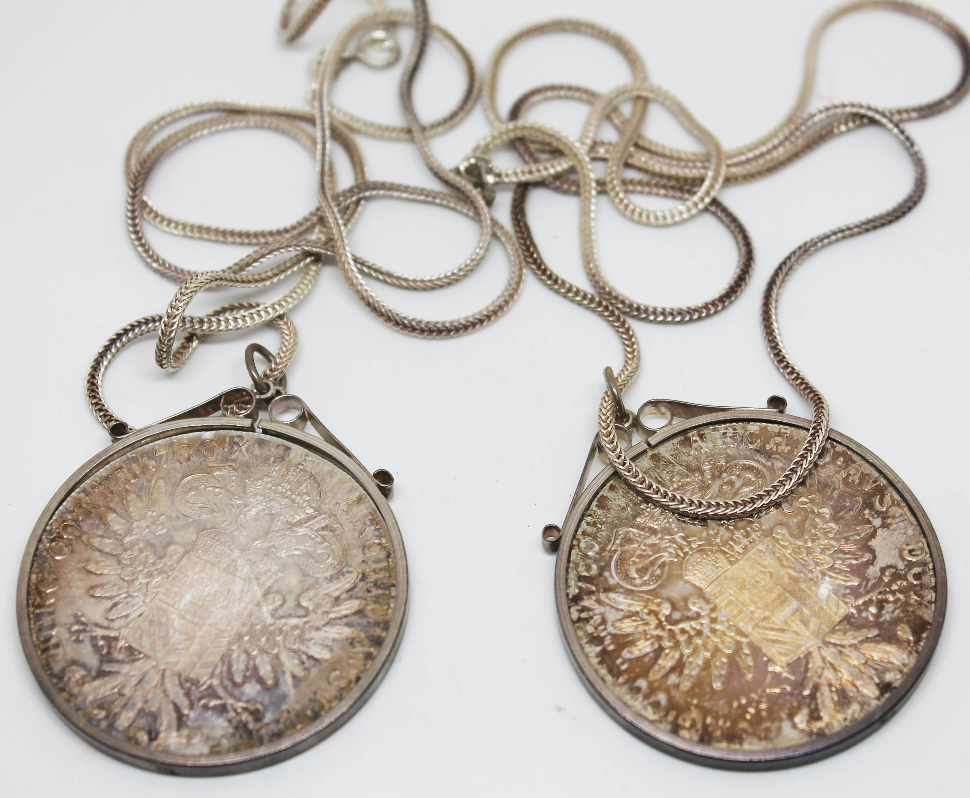 Two silver Thaler bearing date 1780, both mounted and on chains marked '925', gross wt. 74.1g.