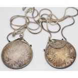 Two silver Thaler bearing date 1780, both mounted and on chains marked '925', gross wt. 74.1g.