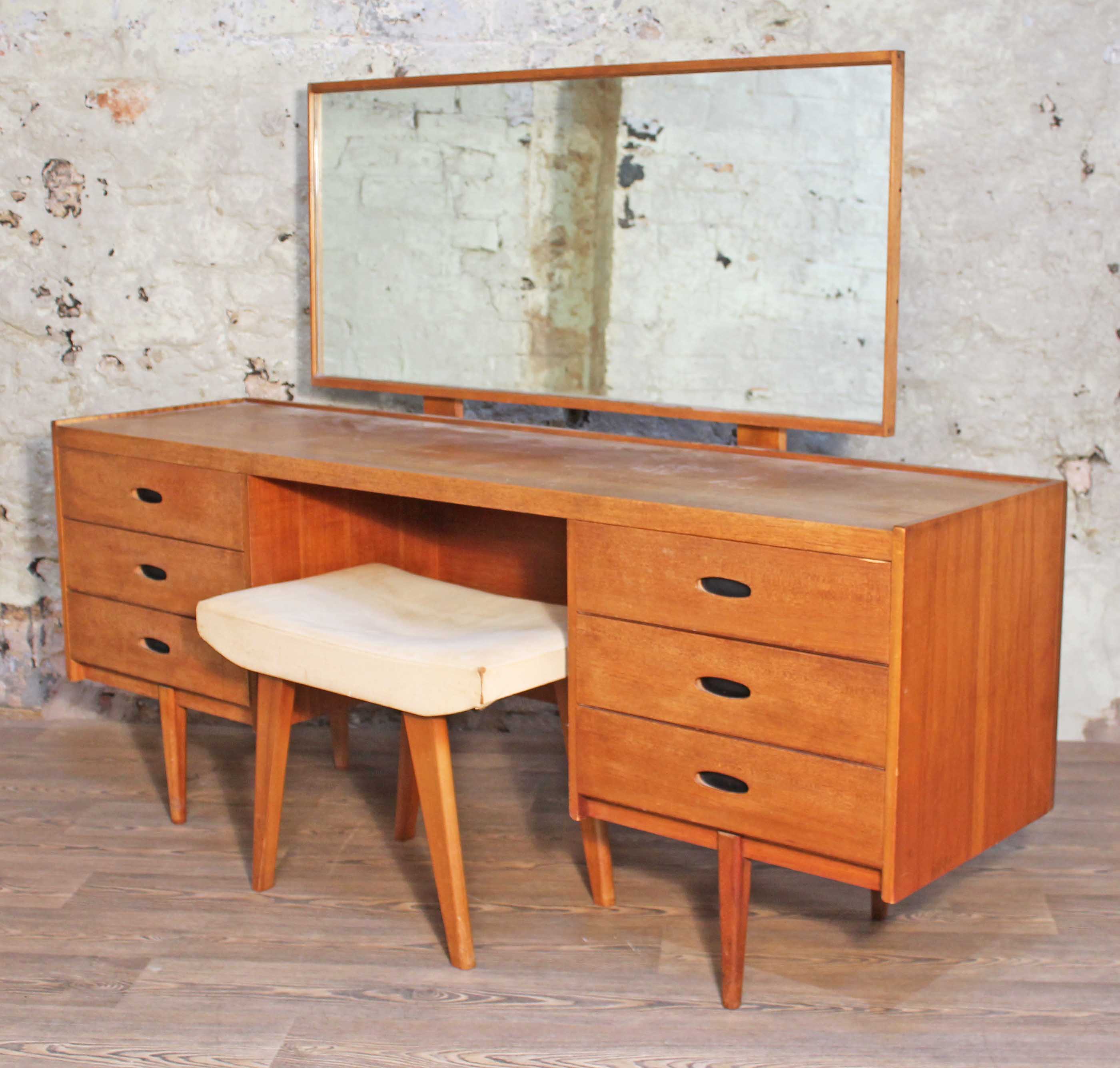 An Austinsuite teak dressing table with adjustable mirror, cut-out handles and stool, length