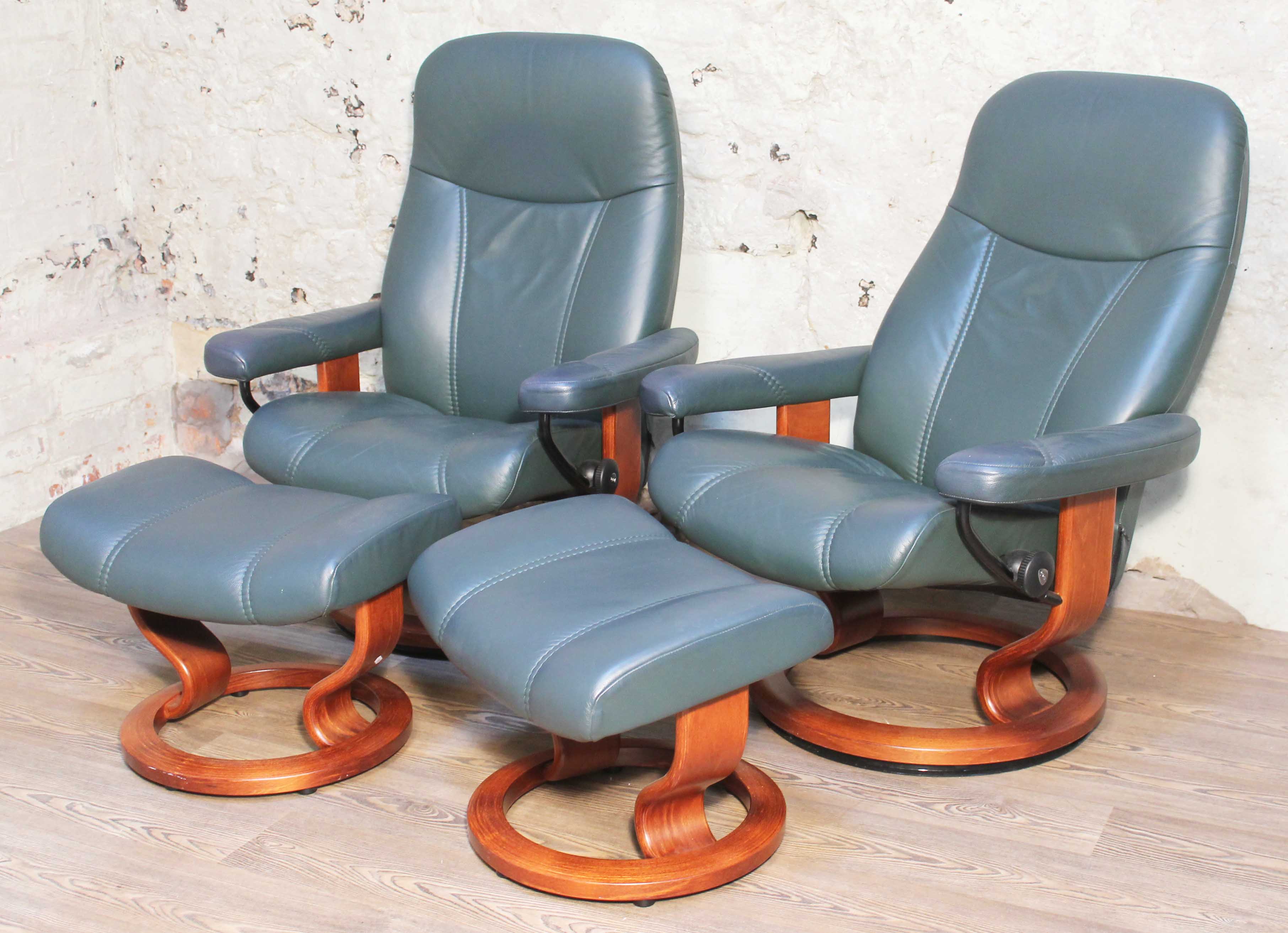 A pair of Norwegian Ekornes Stressless Consul leather and bent wood reclining armchairs with