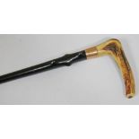 A Victorian ebonised walking stick with antler handle and hallmarked 15ct gold collar, length 88cm.