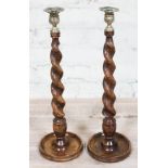 A large pair of twist oak candlesticks with brass terminals, height 47cm.