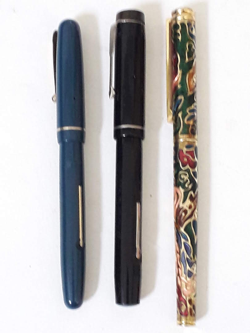 Three vintage fountain pens with gold platinum and iridium nibs.