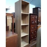 A tall wooden four shelf unit